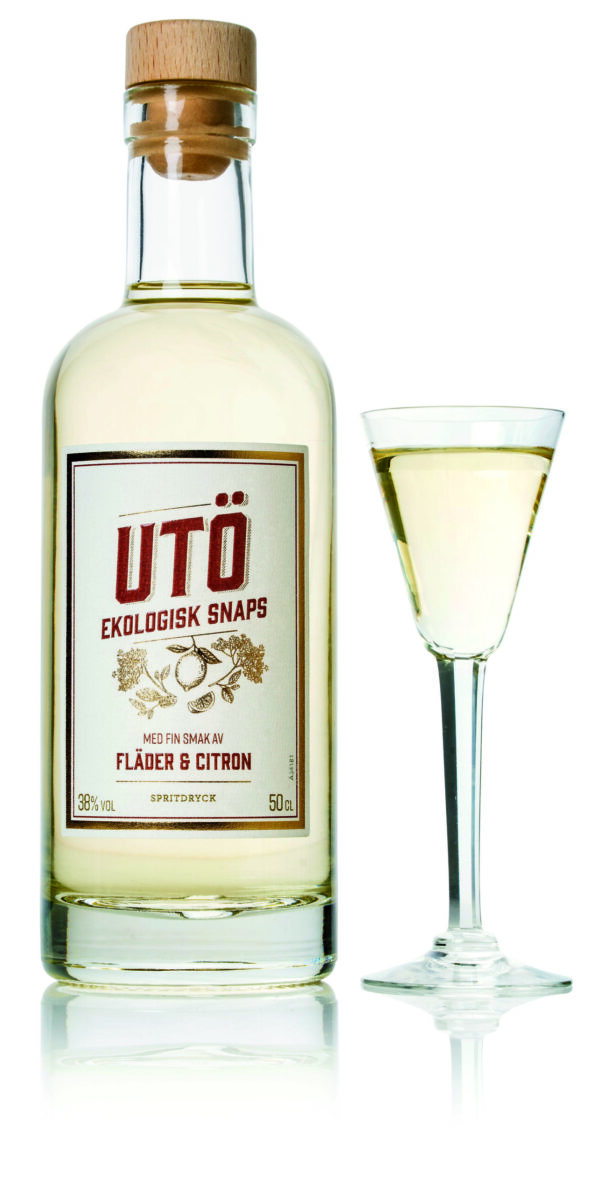 Saturnus Utö 38% Vol. 500ml in Glasflasche mit gefülltem Cocktailglas daneben